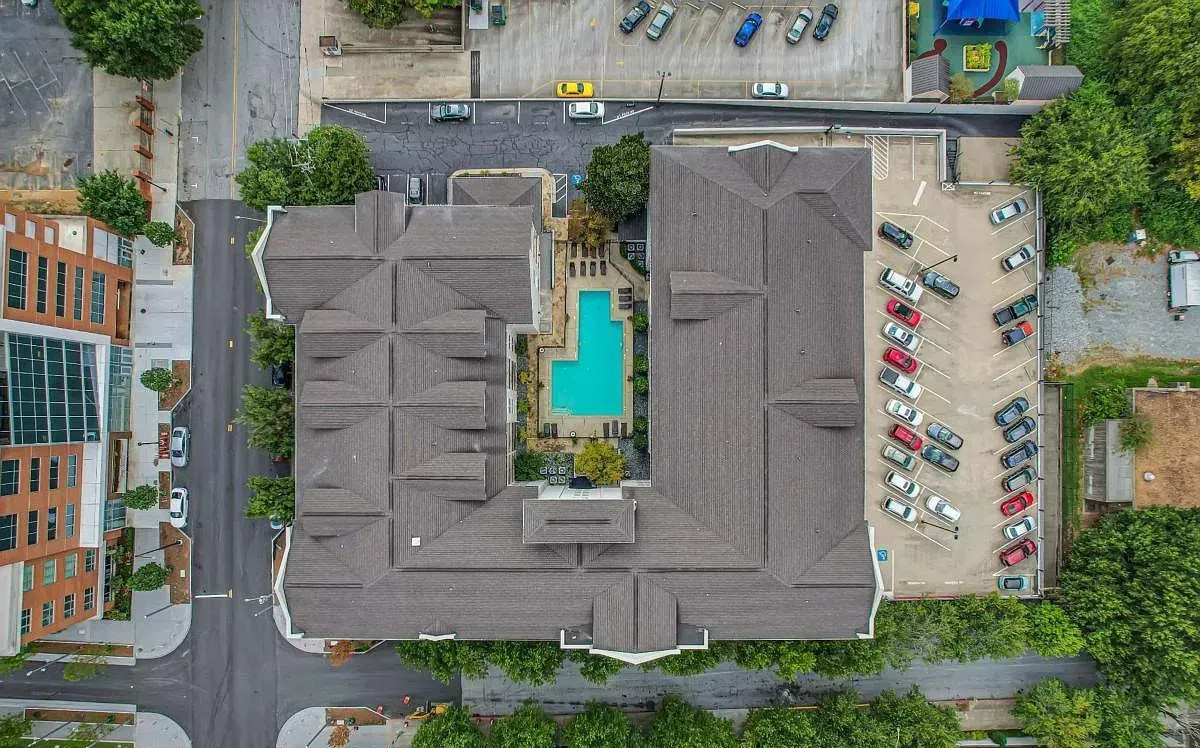 Aerial view of the gated courtyard pool at Peachtree Walk, framed by the building's two wings